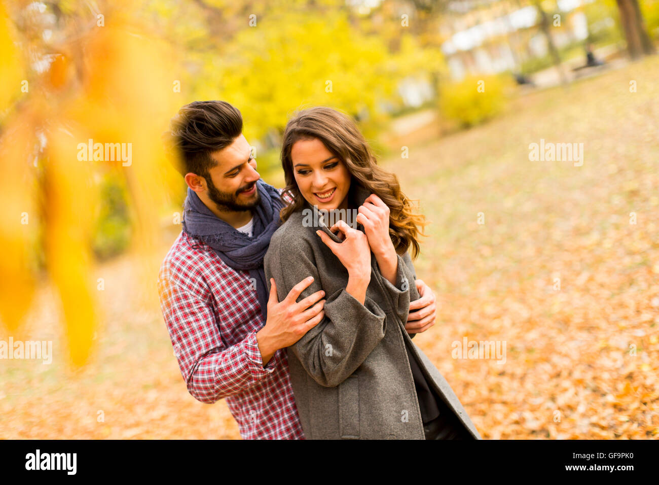 Young loving couple having a walk in the autumn park Stock Photo - Alamy