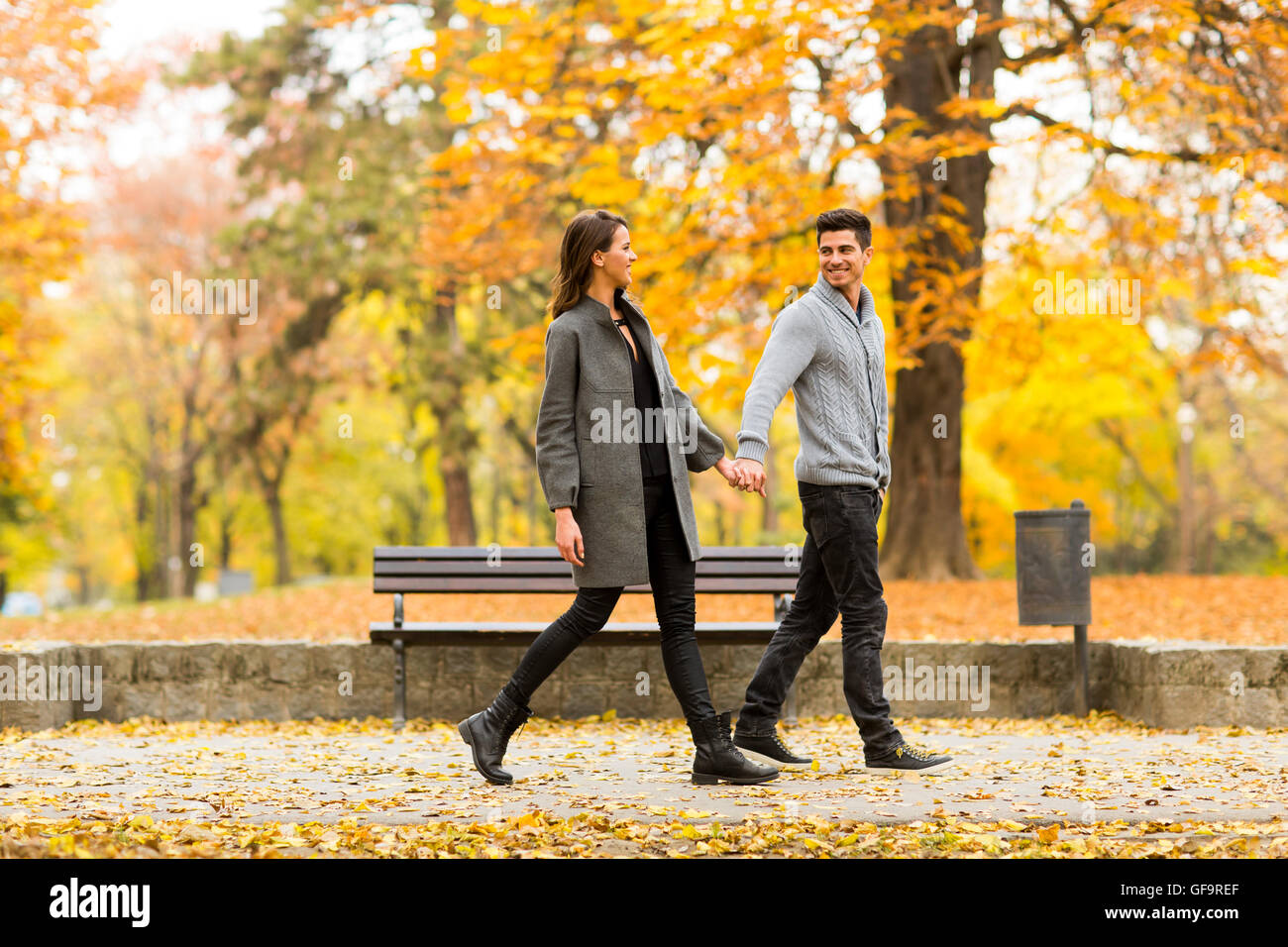 Young loving couple having a walk in the autumn park Stock Photo - Alamy