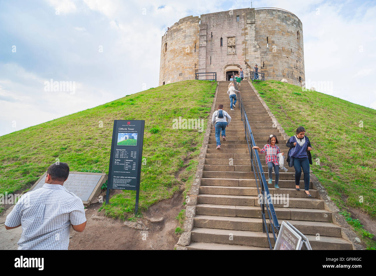 York UK tourism, view of tourists visiting the Norman keep known as Clifford's Tower in the centre of the city of York, Yorkshire, England. Stock Photo