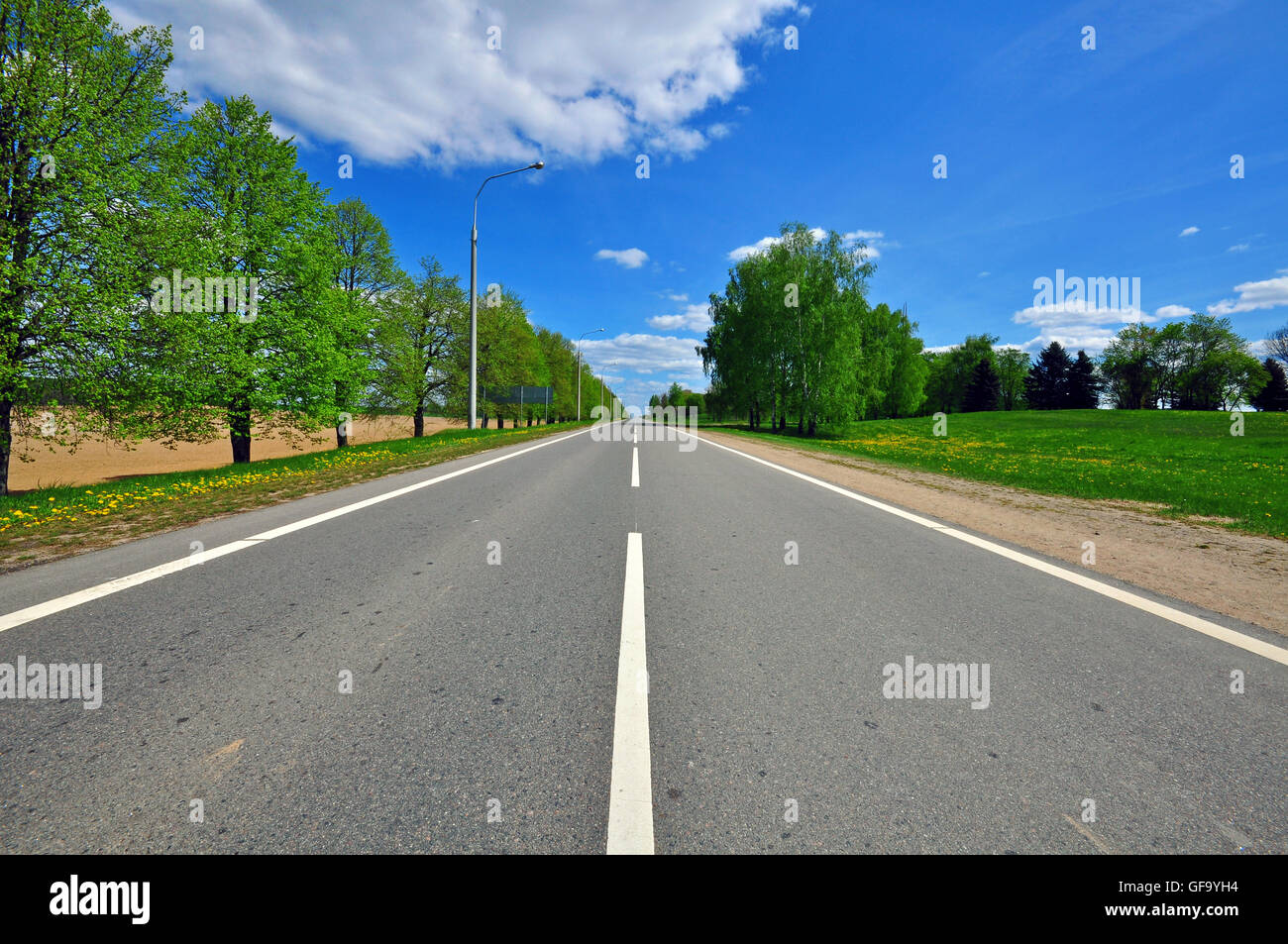 Scenic road and cloudy sky Stock Photo - Alamy