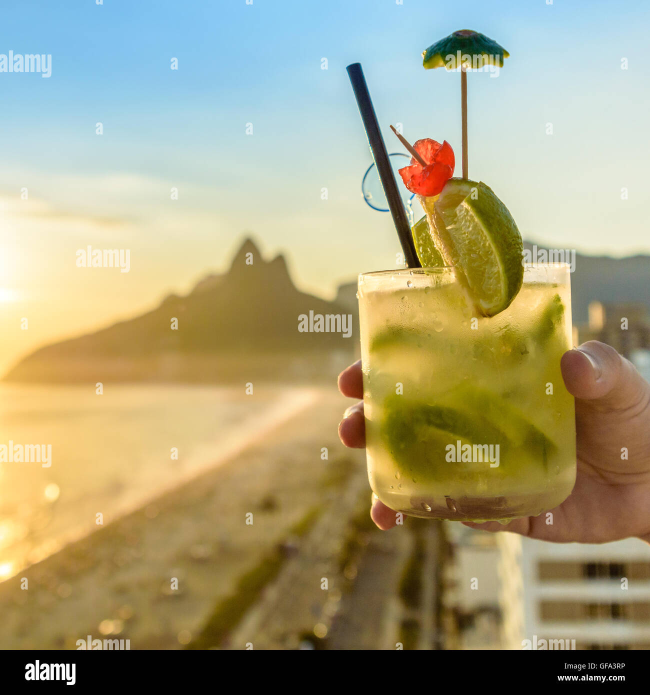 A delicious kiwi caipirinha drink overlooking the iconic Ipanema beach in Rio de Janeiro, Brazil Stock Photo