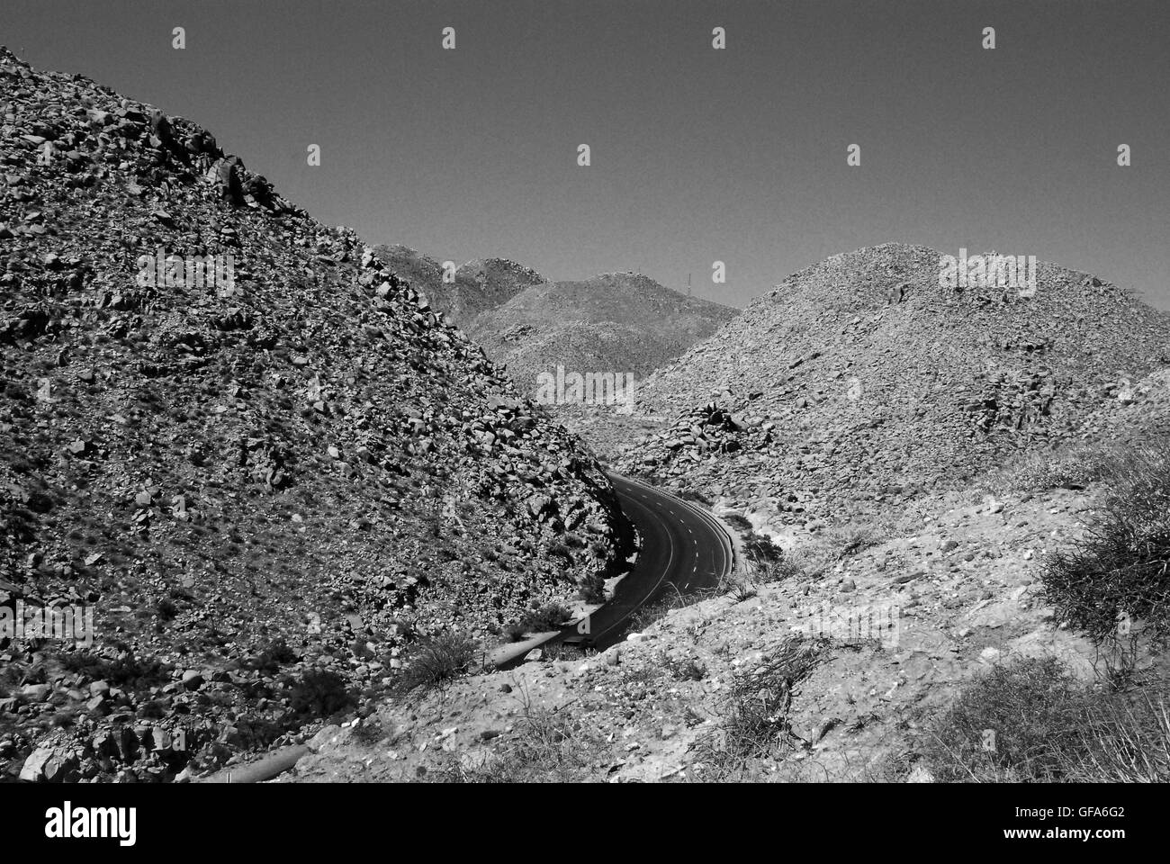 Desert highway through mountains Stock Photo
