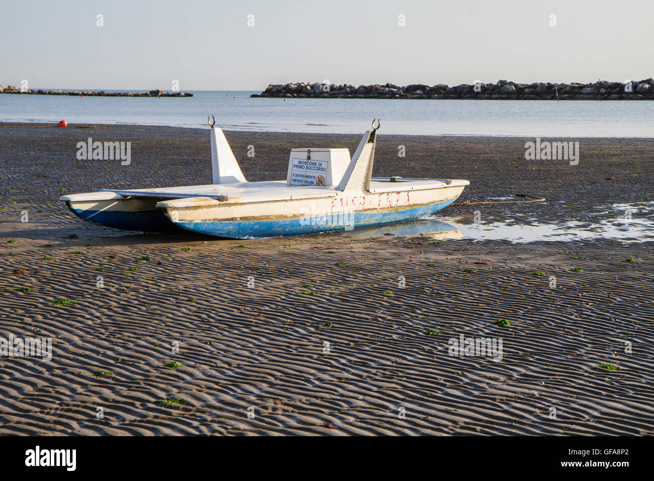 typical wooden lifeboat on the Italian Adriatic coast beach Stock Photo