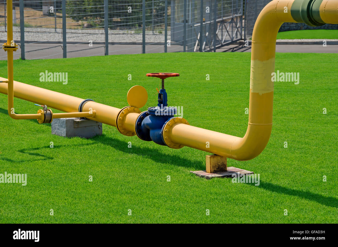 Image of main gas pipe valve overlap on a background of green grass