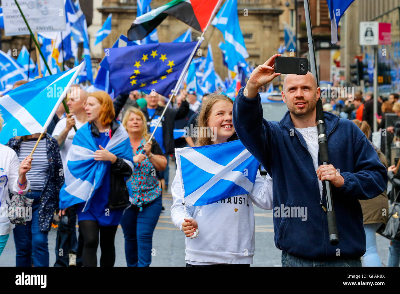 Glasgow, UK. 30th July, 2016. Several thousand people including approximately 100 motorcycles in a rally, took part in a Pro-Independence March through Glasgow, UK, finishing with speeches in George Square in the city centre. 'Under One Banner' is a collective of many smaller groups including 'Yes2', 'Anti-Trident', 'CND' 'Anti-Tory', and similar other pressure groups who support respective aspects of the SNP's policies. Credit:  Findlay/Alamy Live News Stock Photo
