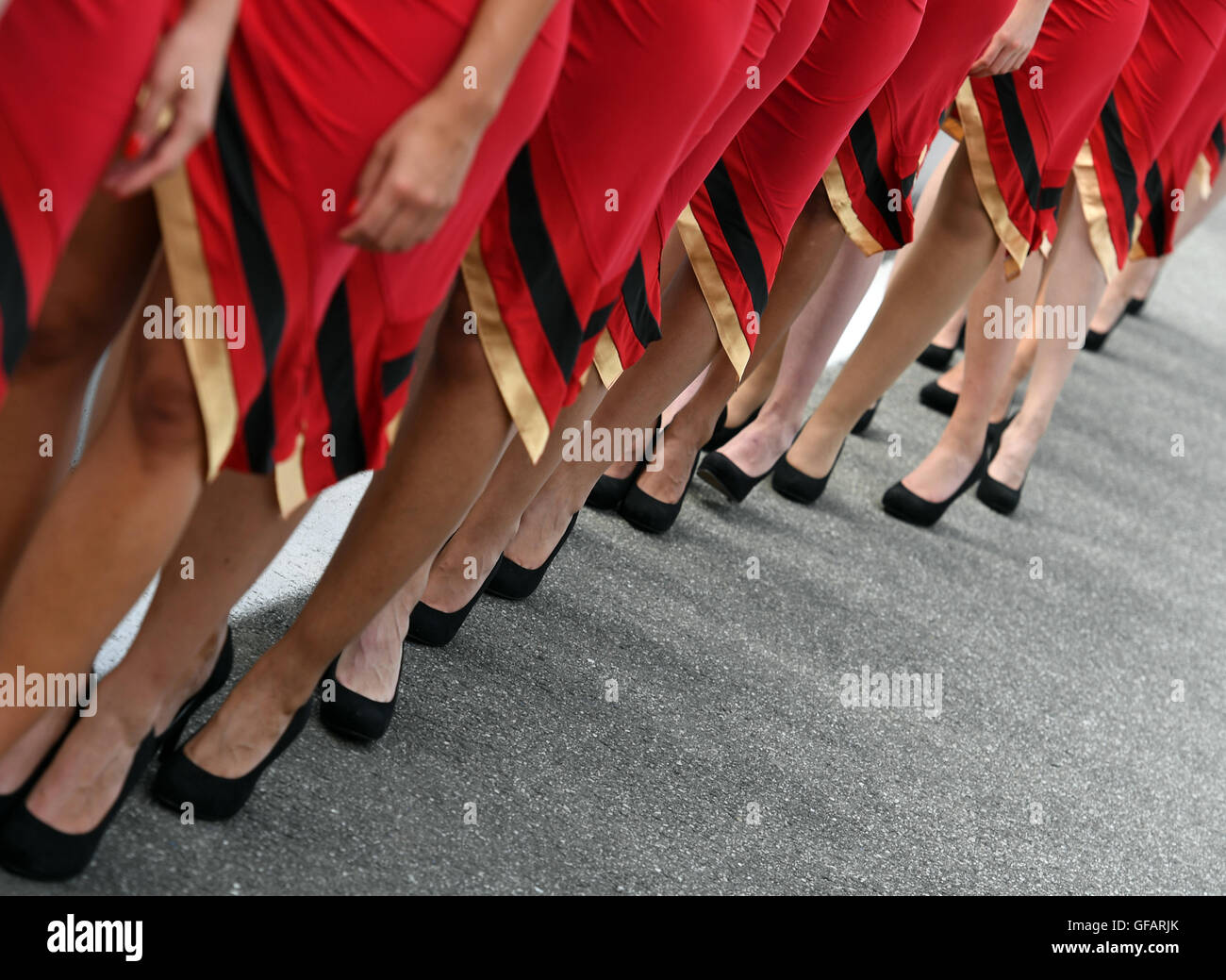 Hockenheim, Germany. 30th July, 2016. Grid Girls stand on the pit lane after the qualifier on the Hockenheimring in Hockenheim, Germany, 30 July 2016. The German Grand Prix takes place on 31 July 2016. Photo: ULI DECK/dpa/Alamy Live News Stock Photo
