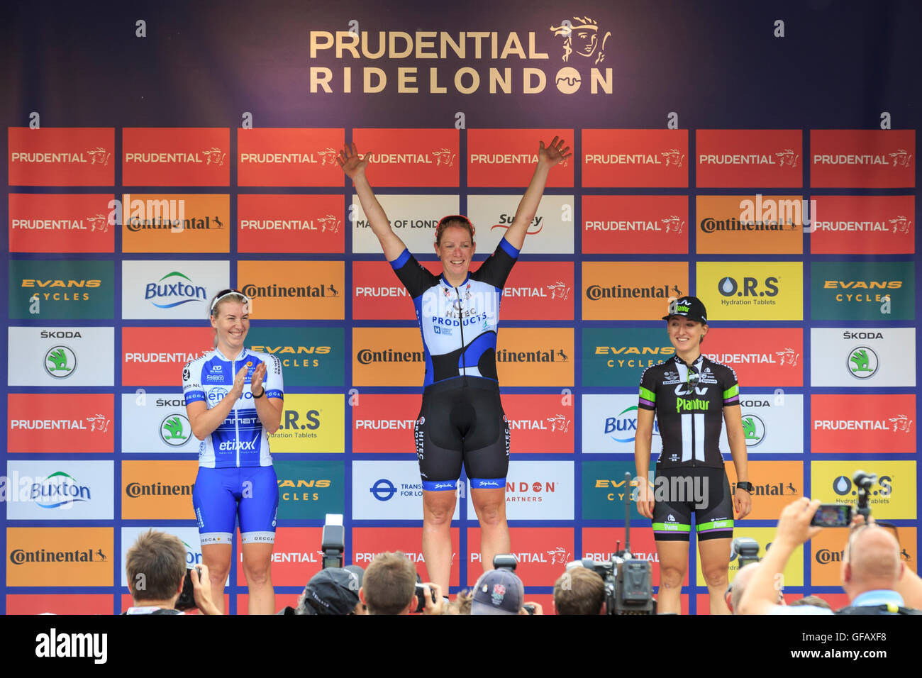 London, UK, 30 July 2016. Prudential RideLondon Classique. Kirsten Wild (centre, Hitec Products) celebrates on the podium of the RideLondon Classique - a 66km race which forms part of the UCI Women's World Tour. Wild won €25,000 - the biggest race prize in women's cycling - and equal to the amount on offer at the men's RideLondon-Surrey Classic. Nina Kessler (left, Lensworld Zannata Etixx) and Leah Kirchmann (right, Team Liv Plantur) completed the podium. Credit:  Clive Jones/Alamy Live News Stock Photo