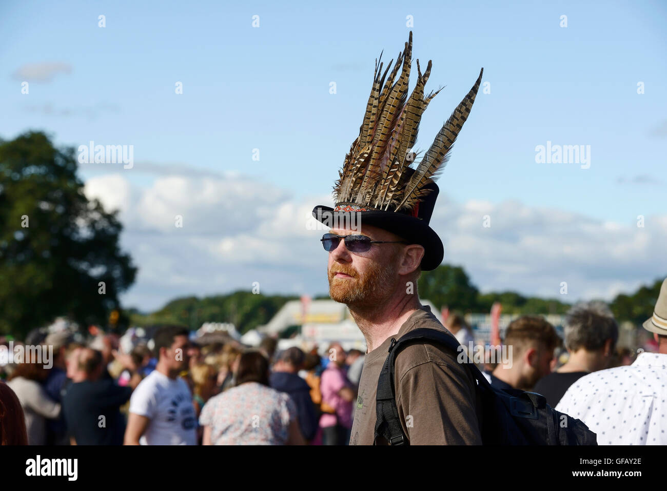Carfest North, Bolesworth, Cheshire, UK. 30th July 2016. A man with feathers in his hat. The event is the brainchild of Chris Evans and features 3 days of cars, music and entertainment with profits being donated to the charity Children in Need. Andrew Paterson/Alamy Live News Stock Photo