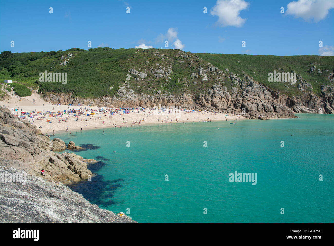 Porthcurno, Cornwall, UK. 31st July 2016. UK Weather. Turqoise blue seas and sunny clear skies for visitors to the beaches at Porthcurno and Treen. Credit:  cwallpix/Alamy Live News Stock Photo