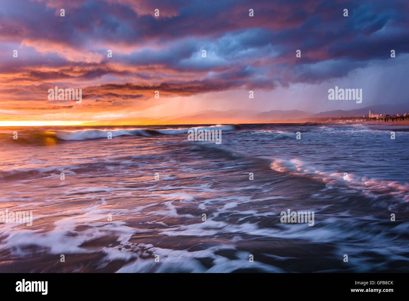 Dramatic stormy sunset and waves in the Pacific Ocean, seen at Venice ...