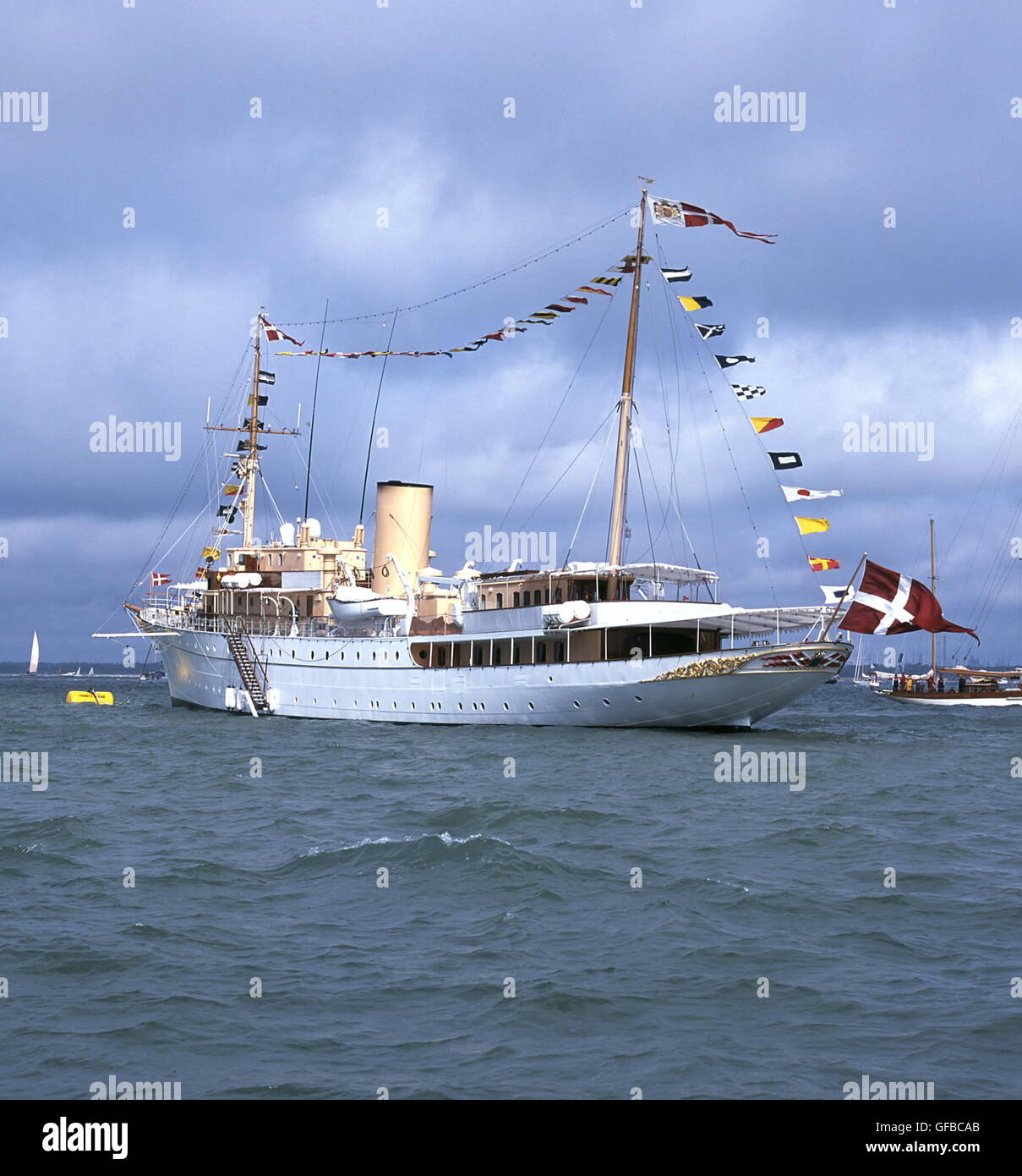 AJAXNETPHOTO. 19TH AUGUST, 2001, COWES, ENGLAND. - DANISH ROYAL YACHT - HDMY DANNEBROG DRESSED OVERALL, ANCHORED OFF COWES DURING THE AMERICA'S CUP SILVER JUBILEE EVENT. YACHT WAS LAUNCHD BY QUEEN ALEXANDRINE IN 1931.  PHOTO:JONATHAN EASTLAND/AJAX  REF:190801 18 Stock Photo