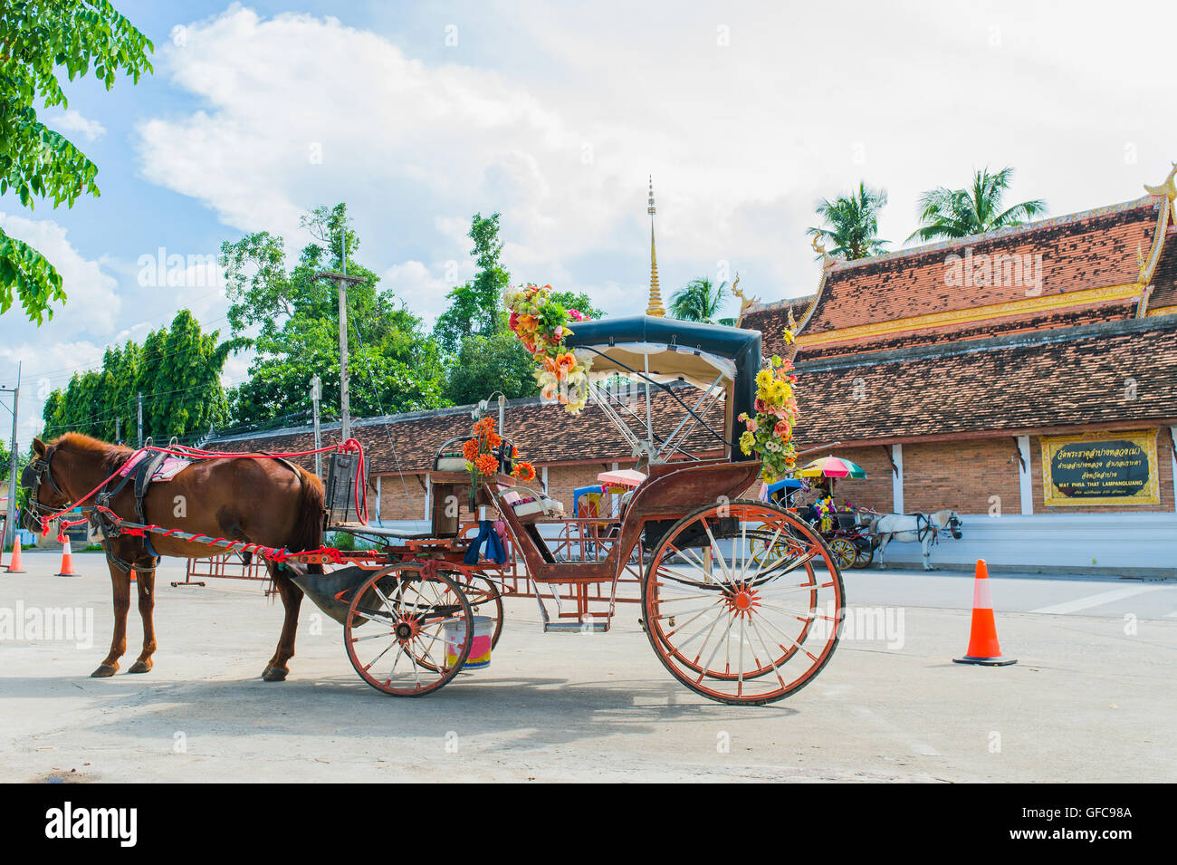 Traditional Horse Carriage ride in Wat Phra That Lampang Luang Stock Photo