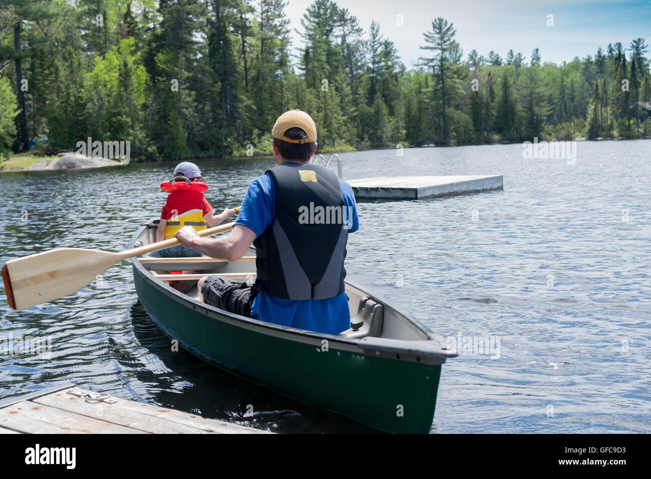 contryside ontario canada nature father and son canoe fishing Stock