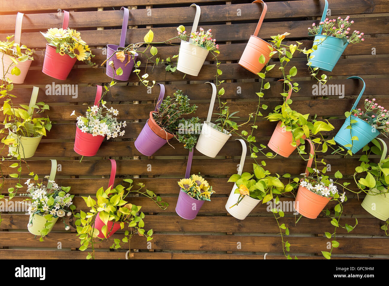 Hanging Flower Pots with fence Stock Photo - Alamy