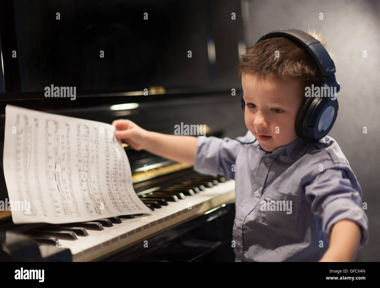Boy listening to music and learning pianocolor image, canon 5DmkII ...