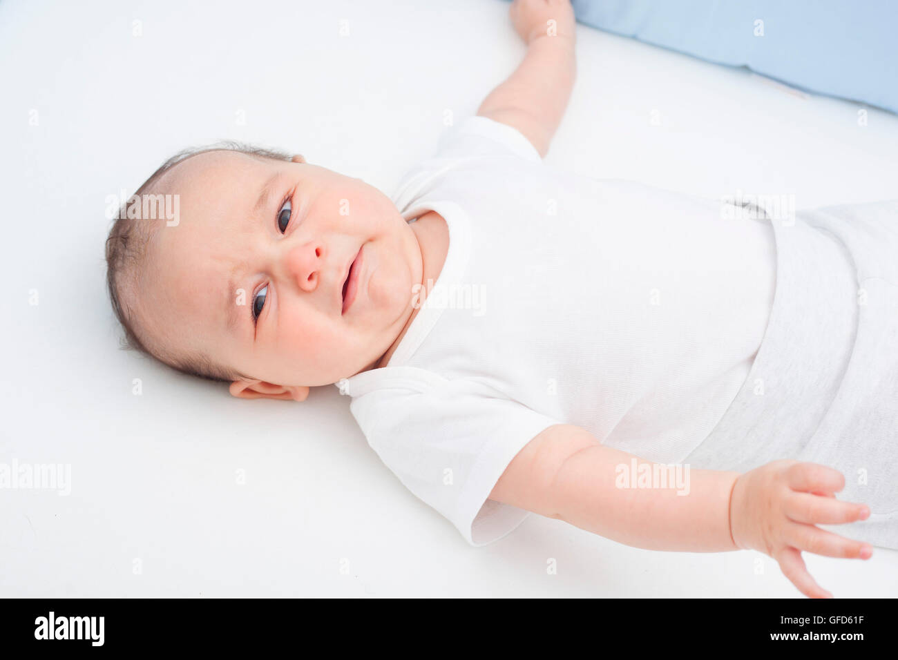 Scared crying baby in his crib Stock Photo Alamy