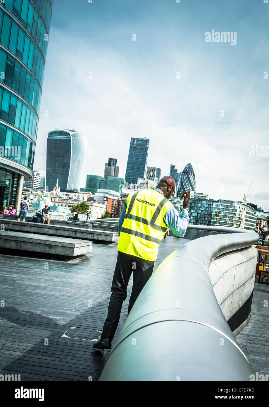A security guard patrolling around the Scoop, Queen's Walk, More London