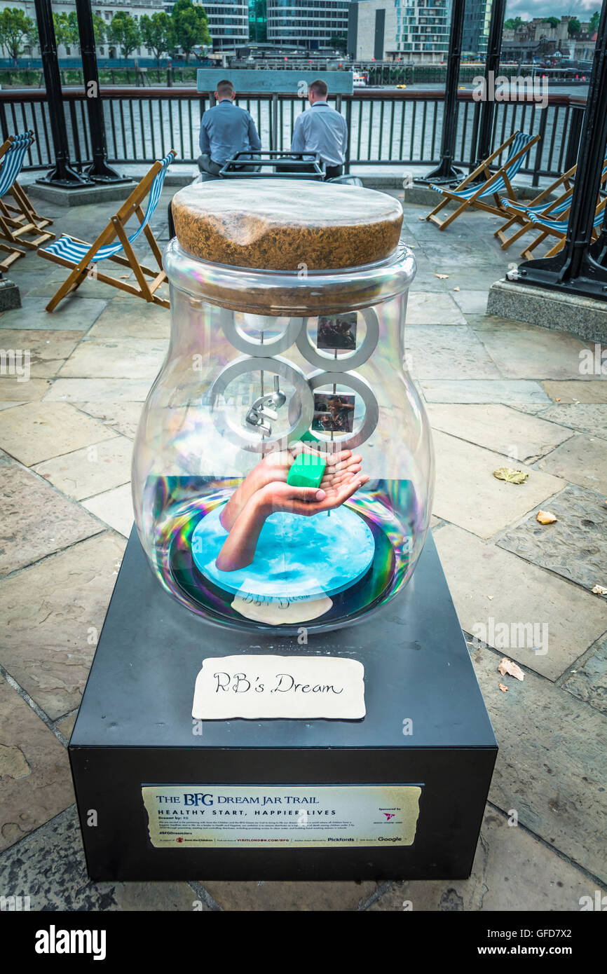 Two men in quiet contemplation near the  BFG Dream Jar Trail next to Tower Bridge in London, UK Stock Photo