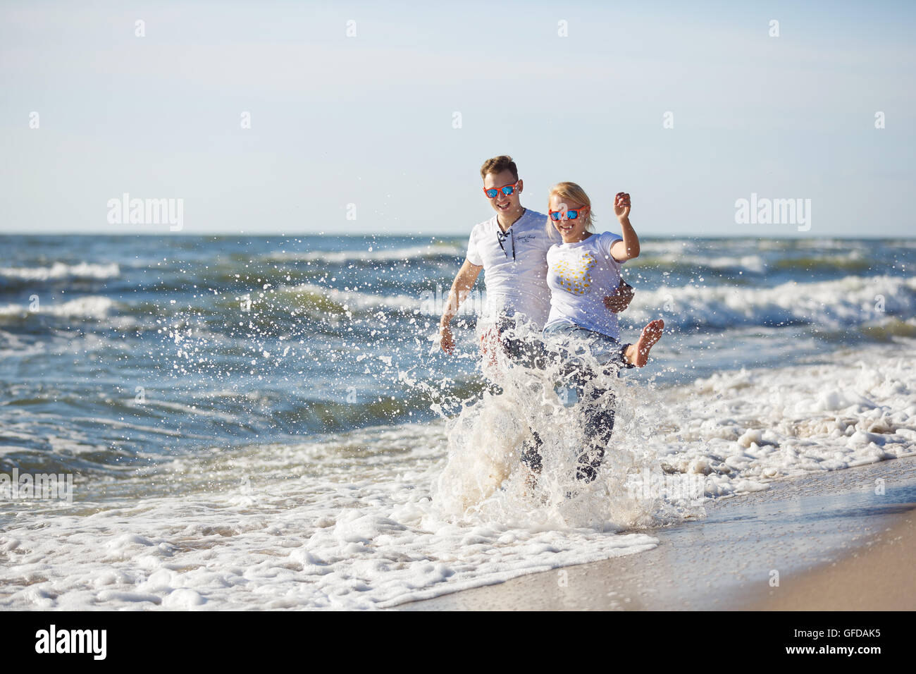 Cheerful couple have fun on the beach, summer time Stock Photo