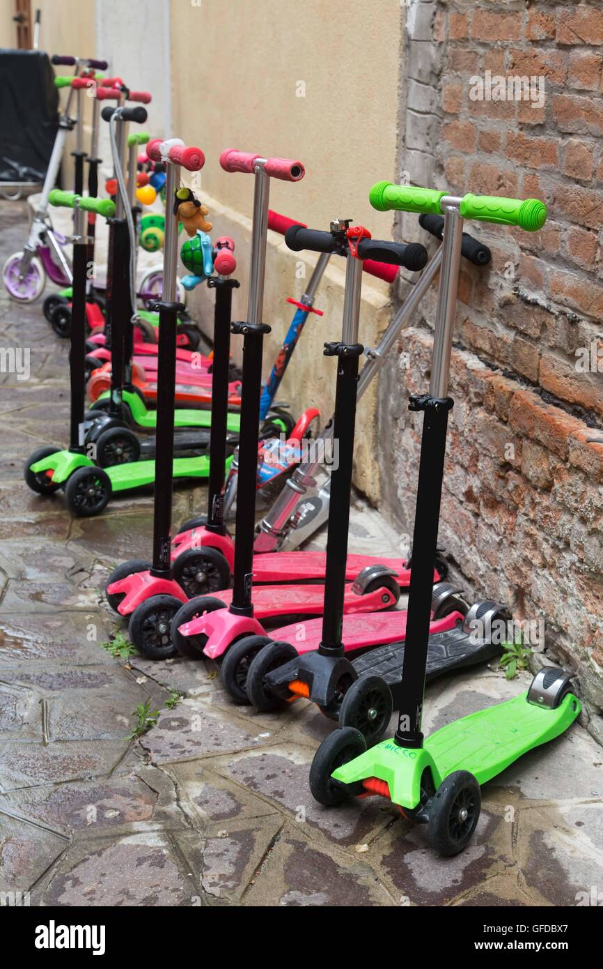 Kid's toy scooters parked in front of the kindergarden Stock Photo