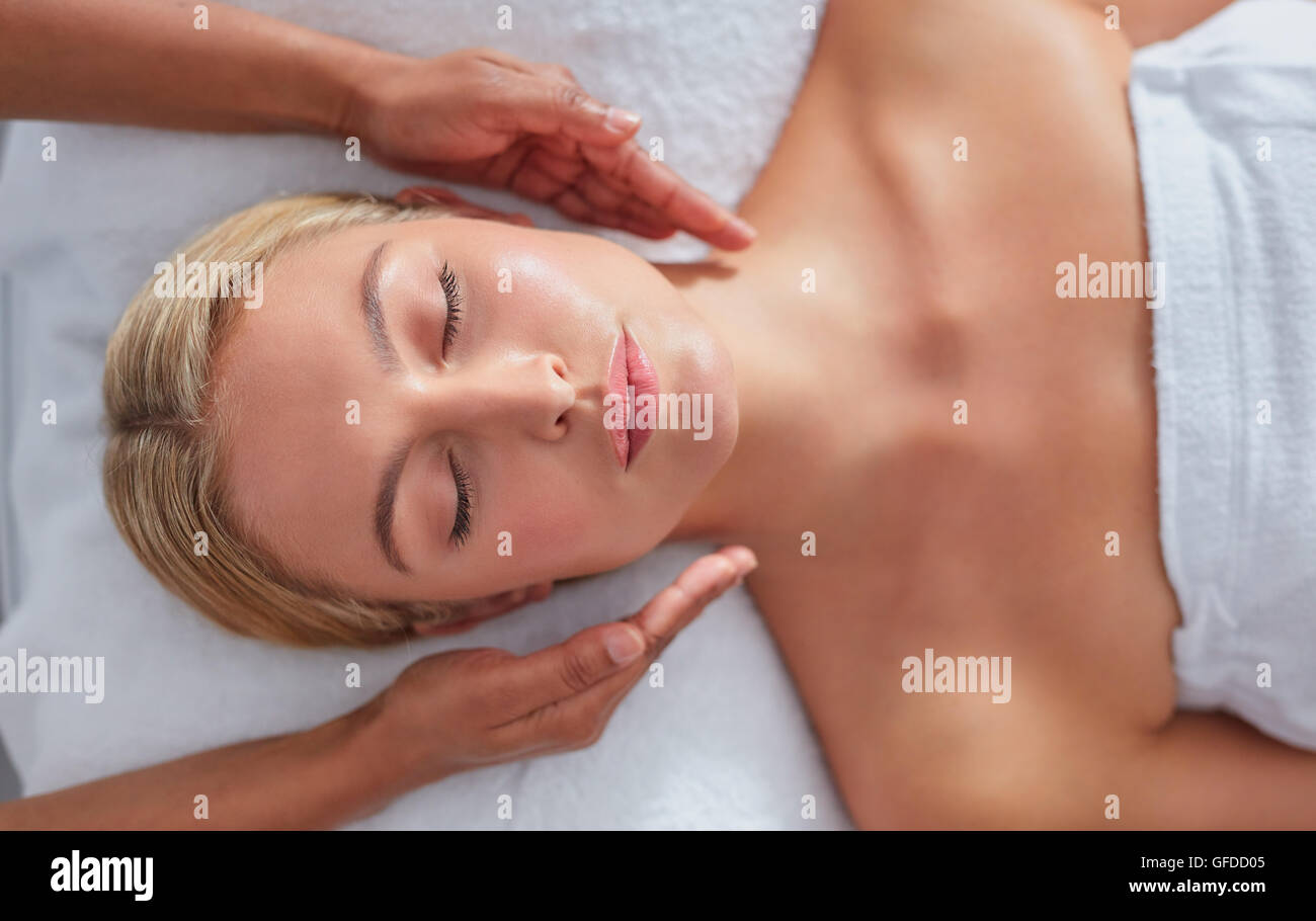 Close up shot of a relaxed woman on massage table receiving beauty treatment at dayspa Stock Photo