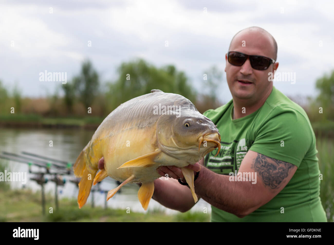 Carp and Fisherman, Carp fishing trophy Selective focus and shallow Depth of field Stock Photo