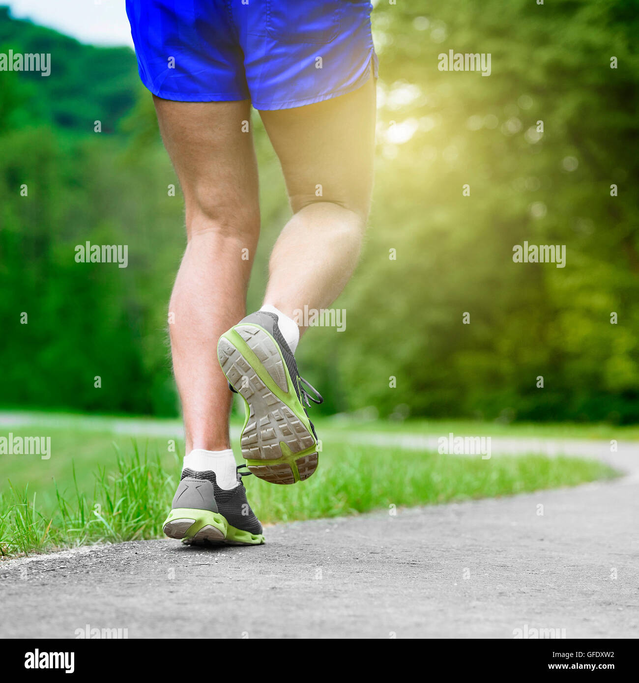 Athlete runner feet running on road closeup on shoe. Man fitness