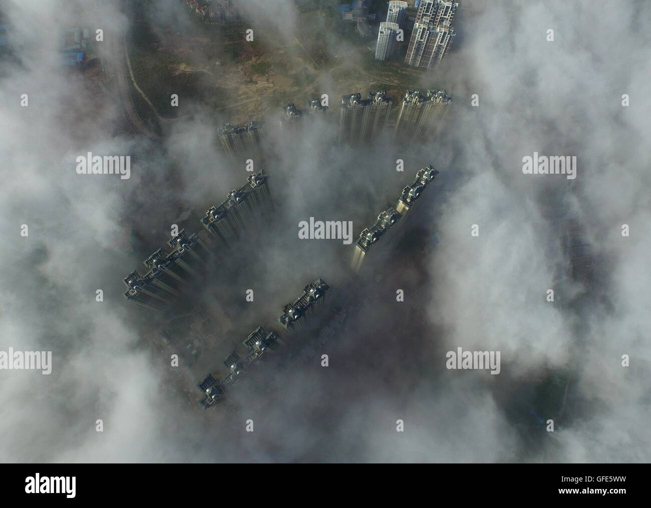 (160730) -- QINZHOU, July 30, 2016 (Xinhua) -- Photo taken on July 30, 2016 shows Qinzhou City enveloped by fog in south China's Guangxi Zhuang Autonomous Region. (Xinhua/Huang Xiaobang)(wyo) (Photo by Xinhua/Sipa USA) Stock Photo