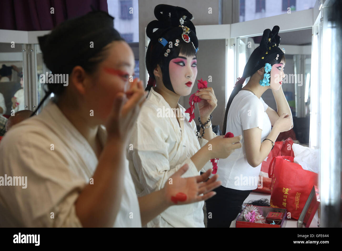 (160730) -- GU'AN, July 30, 2016 (Xinhua) -- Actresses of Hebei Bangzi apply make-up before a performance during 2016 China Hebei Bangzi Festival in Gu'an, north China's Hebei Province, July 29, 2016. Hebei Bangzi, or Hebei Opera, is the main type of opera in Hebei Province which became popular in Qing Dynasty (1644-1911). Like Peking Opera, it's a traditional Chinese opera which combines music, vocal performance, dance, acrobatics and etc. (Xinhua/Cai Yang)(wsw) (Photo by Xinhua/Sipa USA) Stock Photo