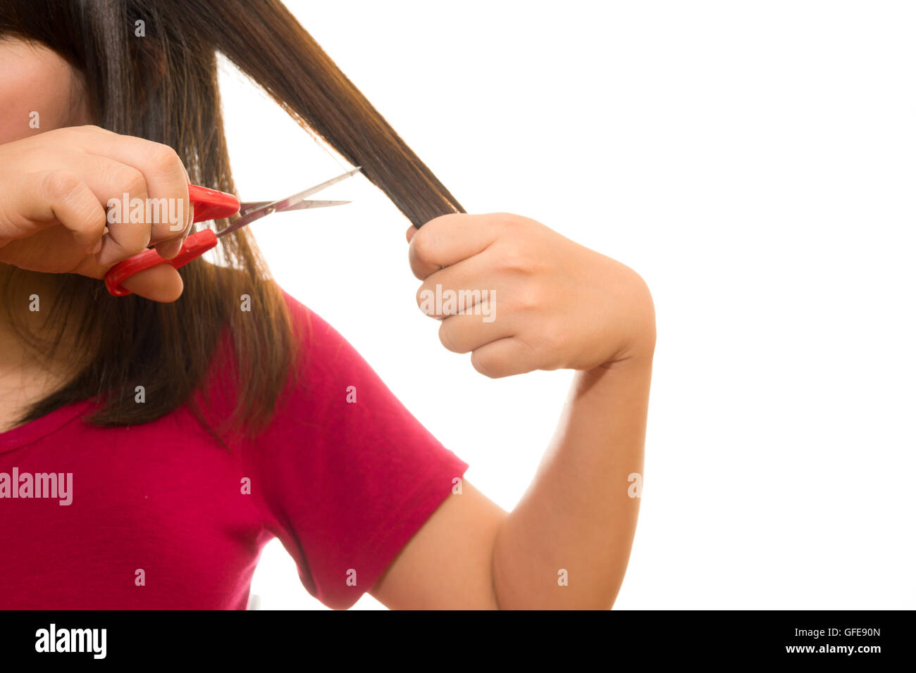 woman cutting her hair with scissors - unhappy expression, isolated on white background Stock Photo