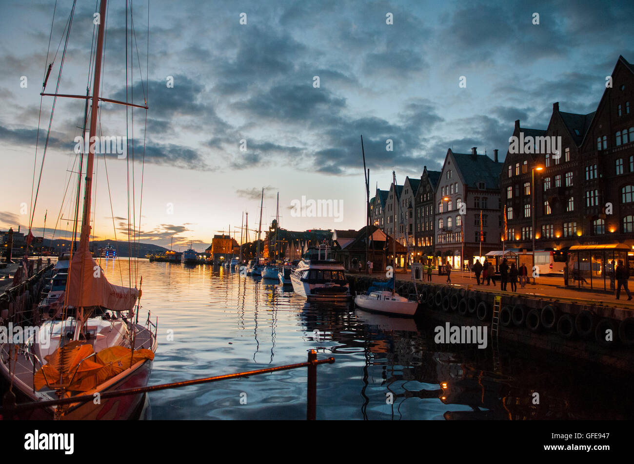 Bergen, Norway. The waterfront at sunset with the wooden Bryggen wharf further down the harbour. Stock Photo