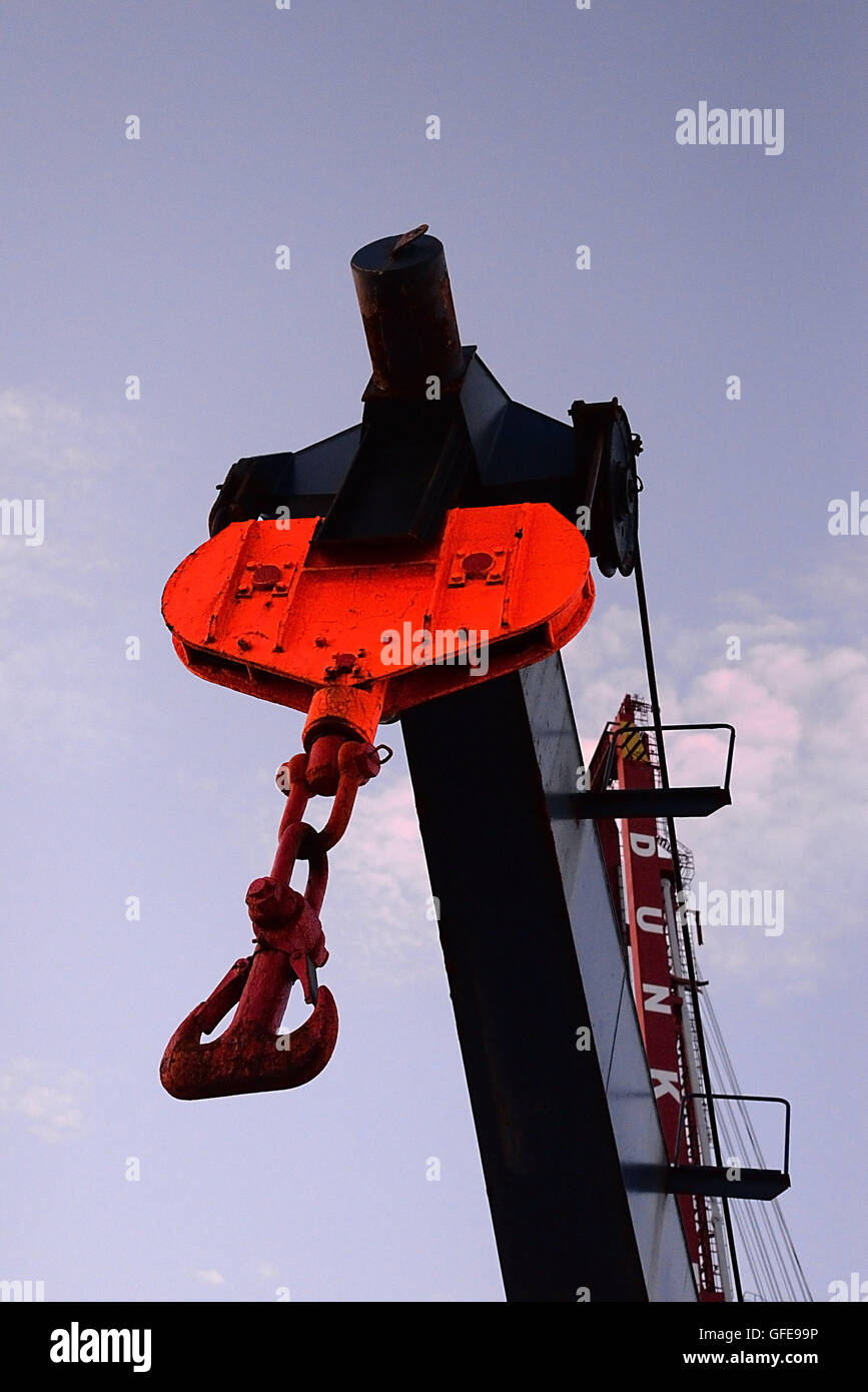 Lifting chain and grab hooks attached to crane high up in Dunkirk harbour. Stock Photo