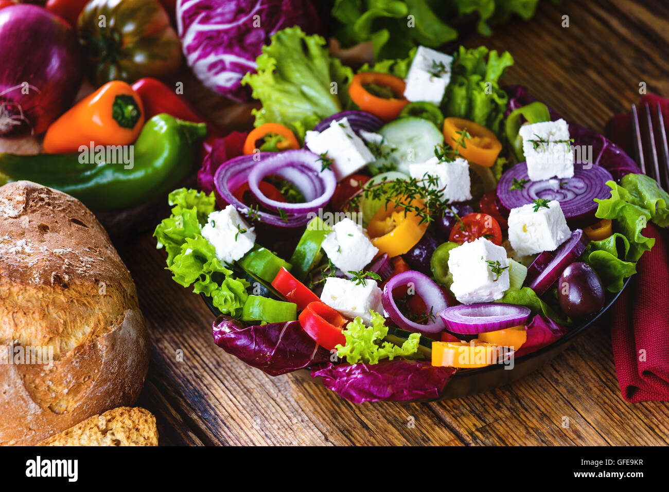 Crisp spring salad with feta cheese, full of vitamins and colors. Greec Salad on vintage table Stock Photo