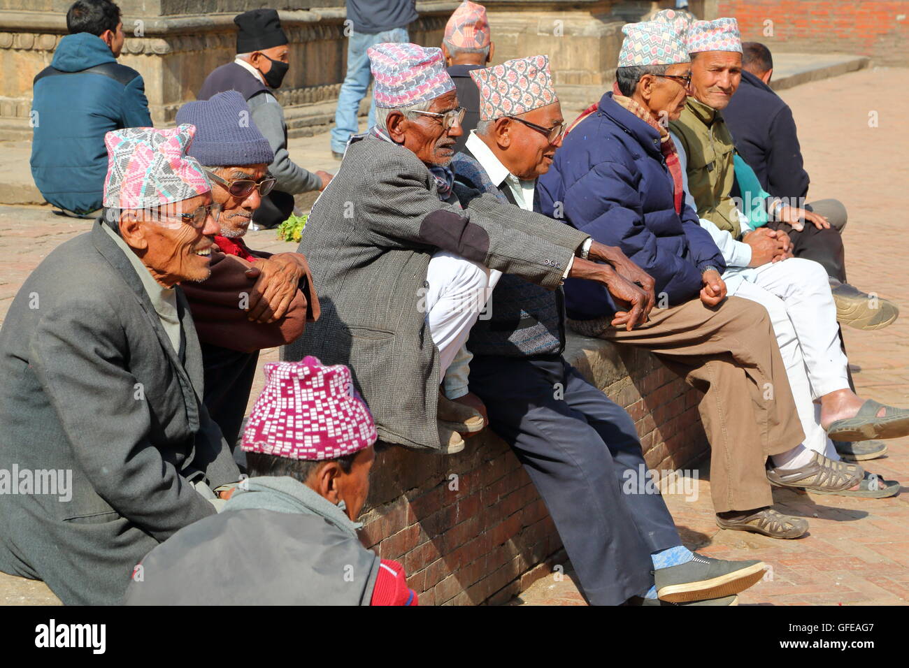 Nepalese men gathering and wearing Dhaka Topi (traditional Nepalese hat) at Durbar Square in Patan, Nepal Stock Photo