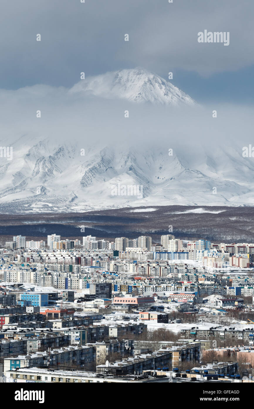 Top view of Petropavlovsk-Kamchatsky City and active Koryak Volcano on a cloudy day. Russian Far East, Kamchatka Peninsula. Stock Photo
