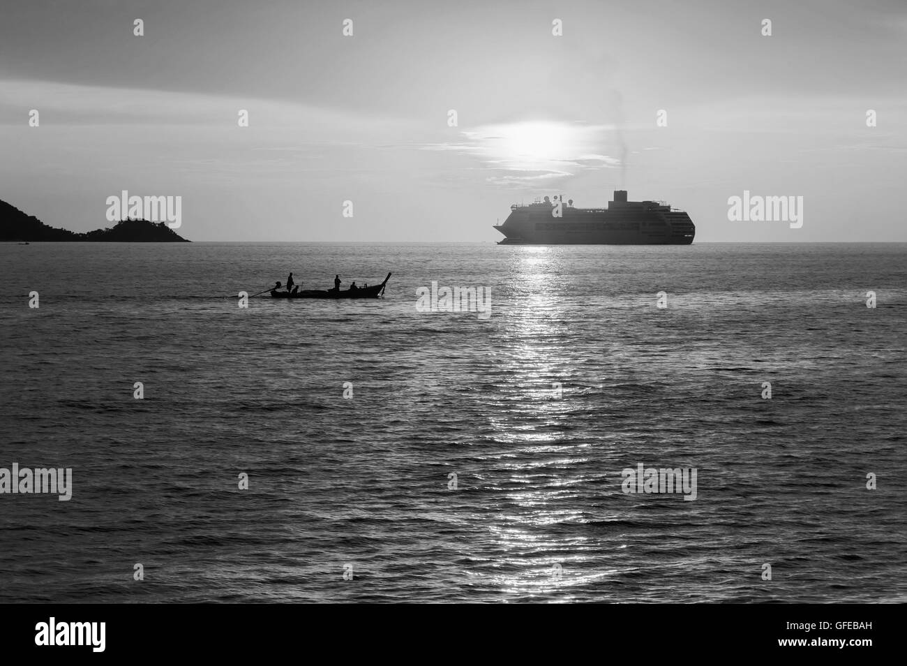 Dramatic sea and transport boat with sunset and over light the sun in twilight black and white tone Stock Photo