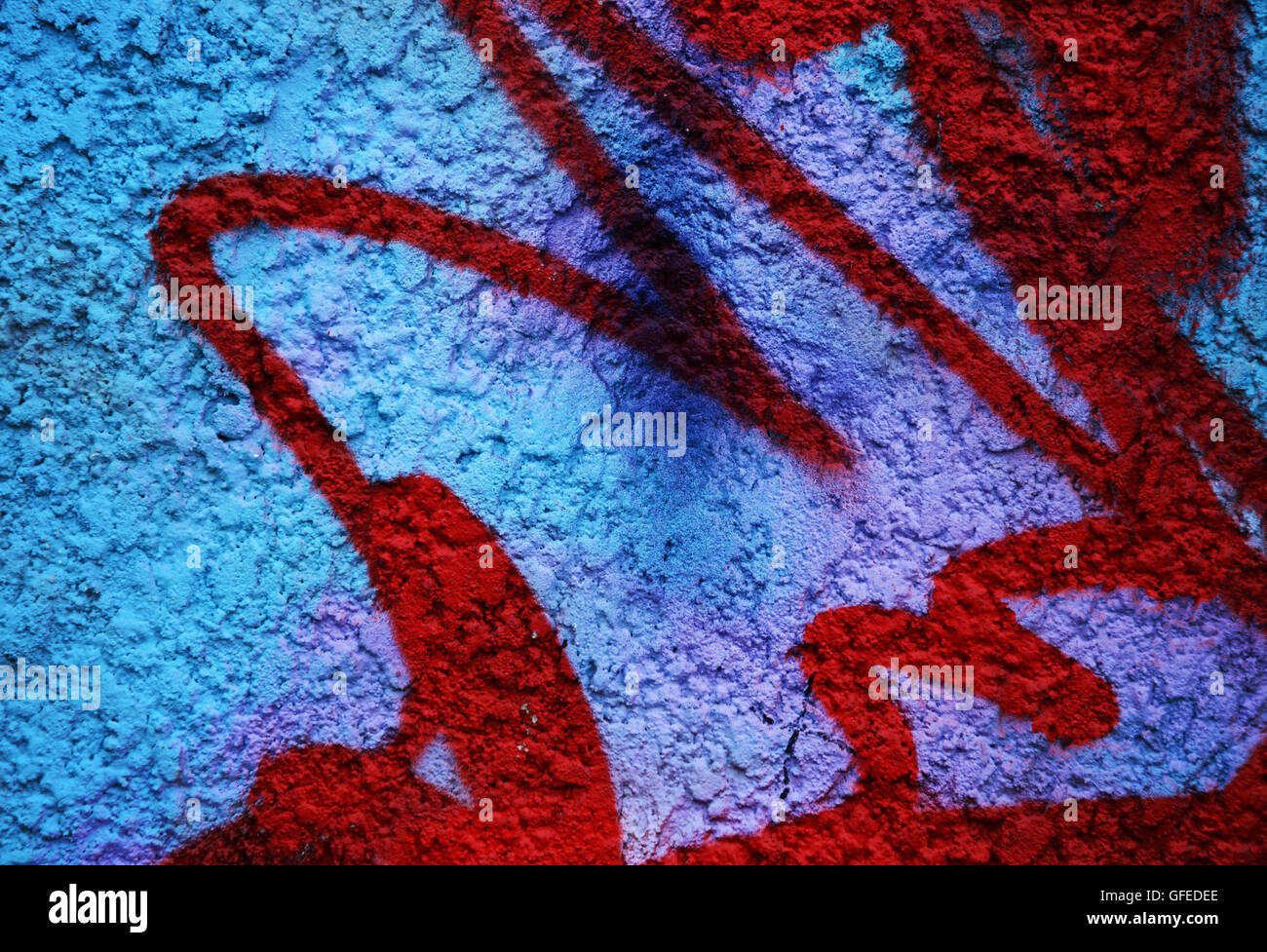 Dramatic grunge painted bright blue street wall with red stripes in abandoned city  area - creative background for your design Stock Photo