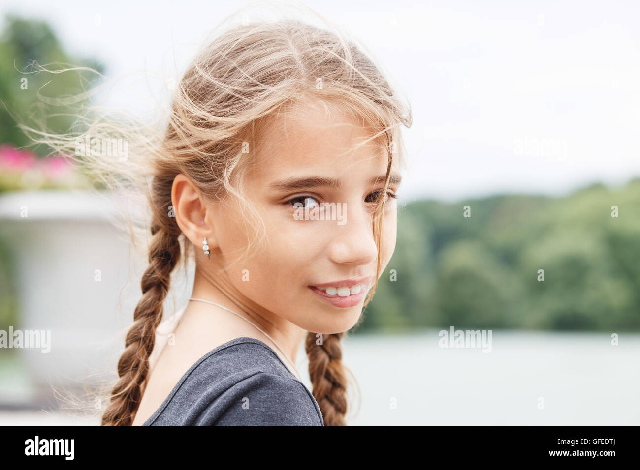 Portrait of young happy girl with braids looking into camera Stock ...