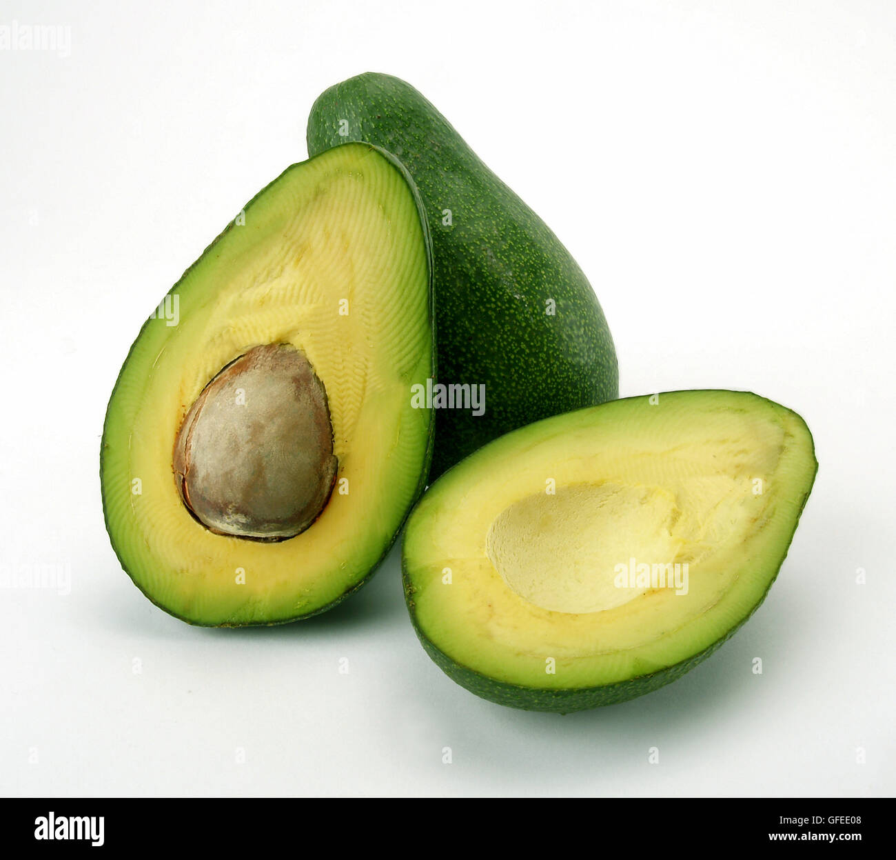 a cut and a whole avocado on white background Stock Photo - Alamy