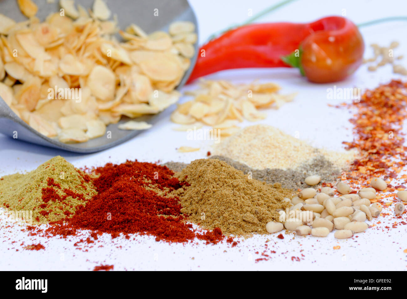 Still life of herbs and spices on white table Stock Photo