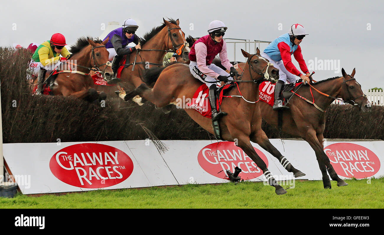 Runners and riders in The Lord Hemphill Memorial Handicap Steeplechase during day seven of the Galway Festival in Ballybrit, Ireland. Stock Photo
