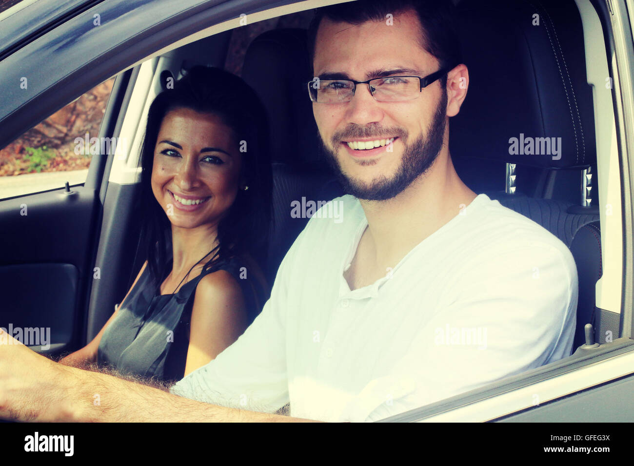 Young couple smiling in a car Stock Photo - Alamy
