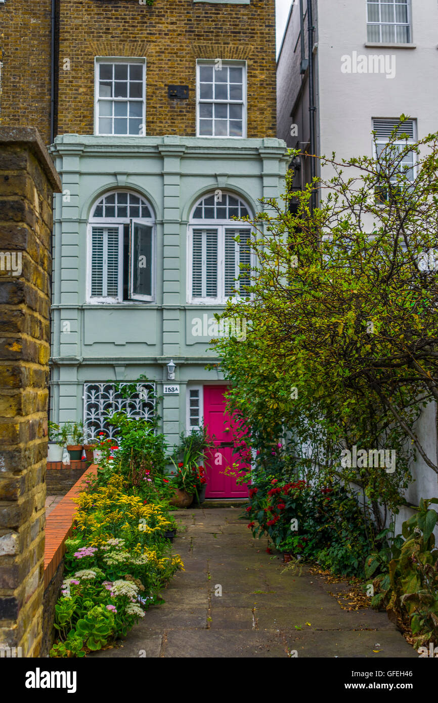 A cute house on Clapham Road – the planting first caught my eye, then the pink door and green paintwork – all works in harmony Stock Photo