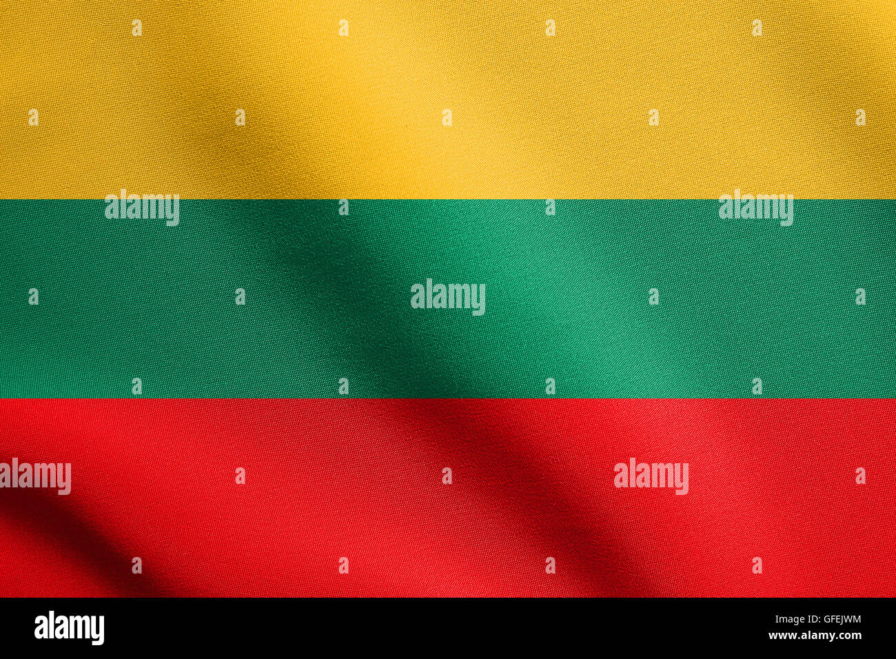 Flag of Lithuania waving in the wind with detailed fabric texture. Lithuanian national flag. Stock Photo