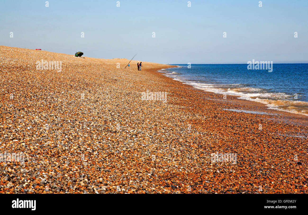A view of two anglers fishing from the shingle beach on the North