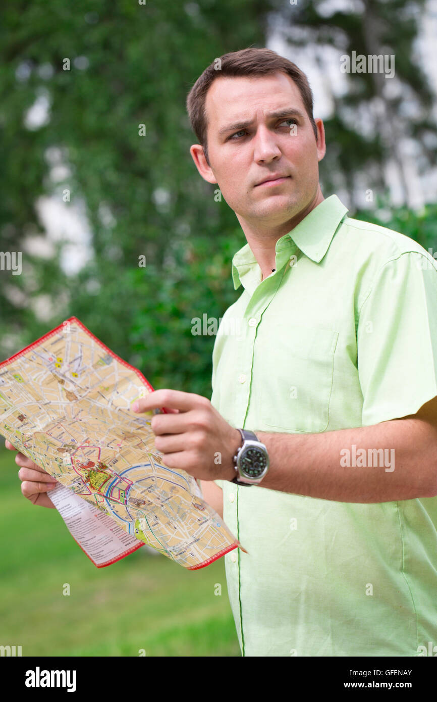 Young male tourist with map in hand looking around. Tourist map of the city of Moscow, Russia (no trademark) Stock Photo