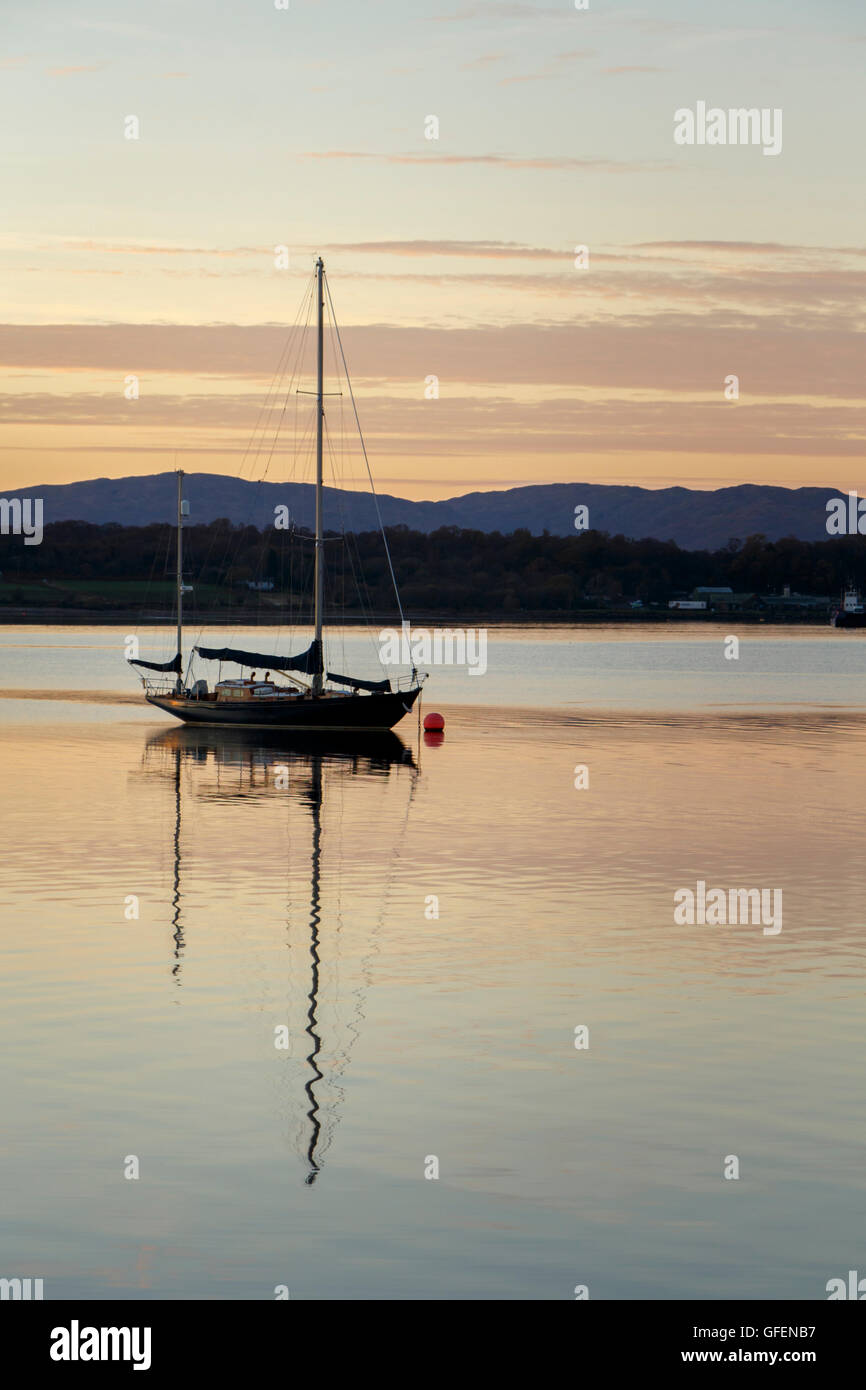 A boat on a lake at Sunset / Sunrise. Taken at Loch Ness, Scotland Stock Photo