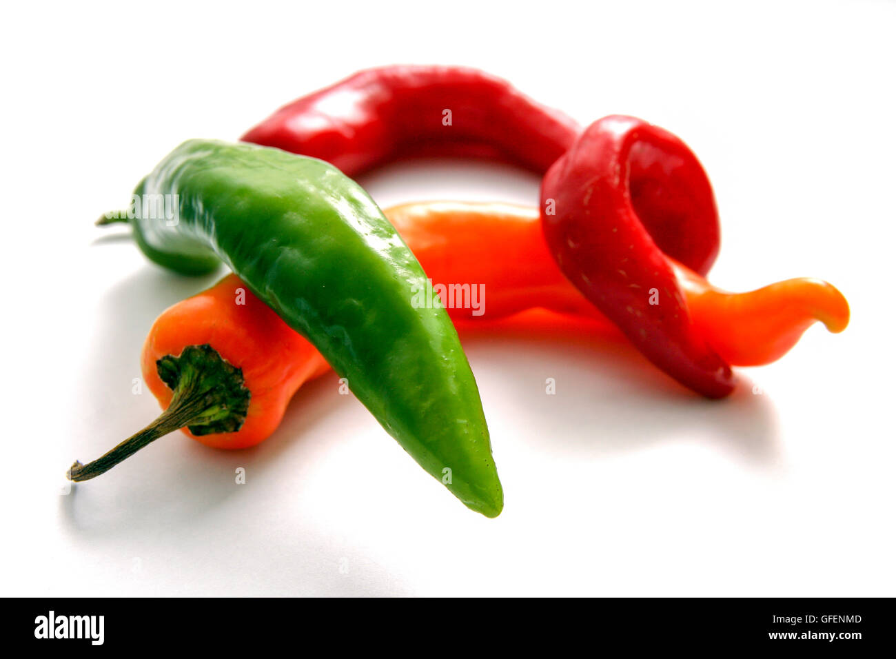 Cutout of an assortment of long hot peppers on white background Stock Photo