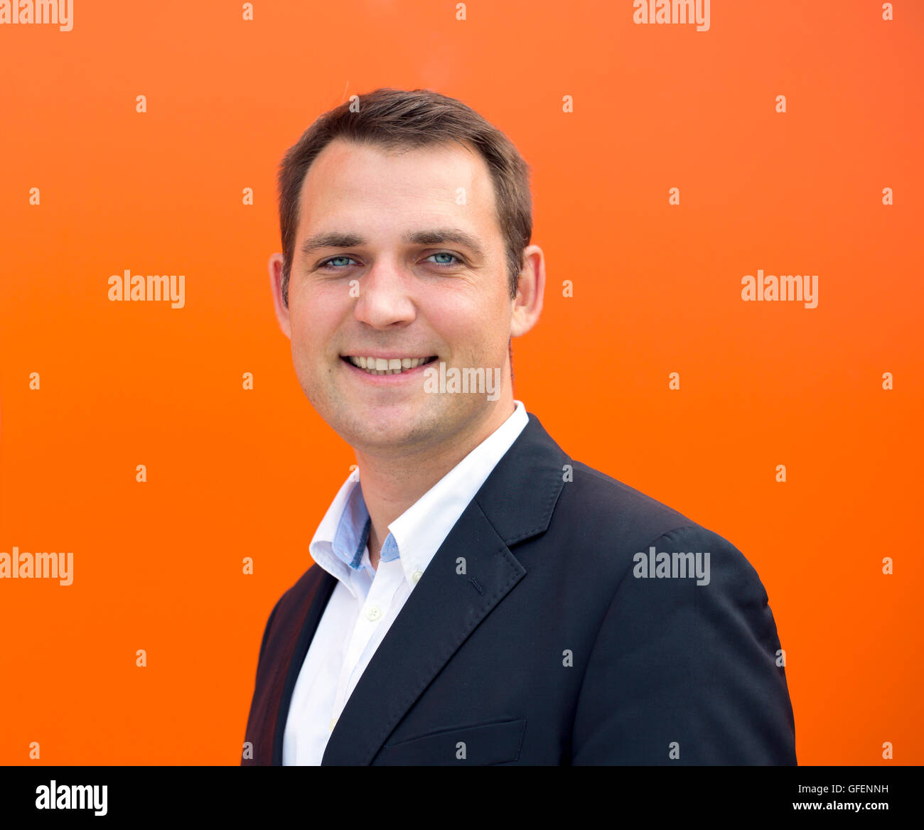 Close up portrait of a young business man in a dark suit and white ...