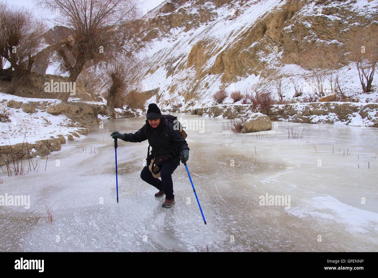 A Lady trekking over the frozen riverbed (Ladakh, India) Stock Photo